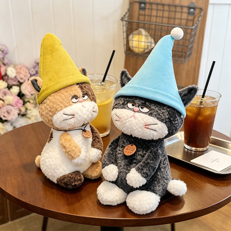  Healing Black and White Cat Plush Toy with Blue Hat on Coffee Table