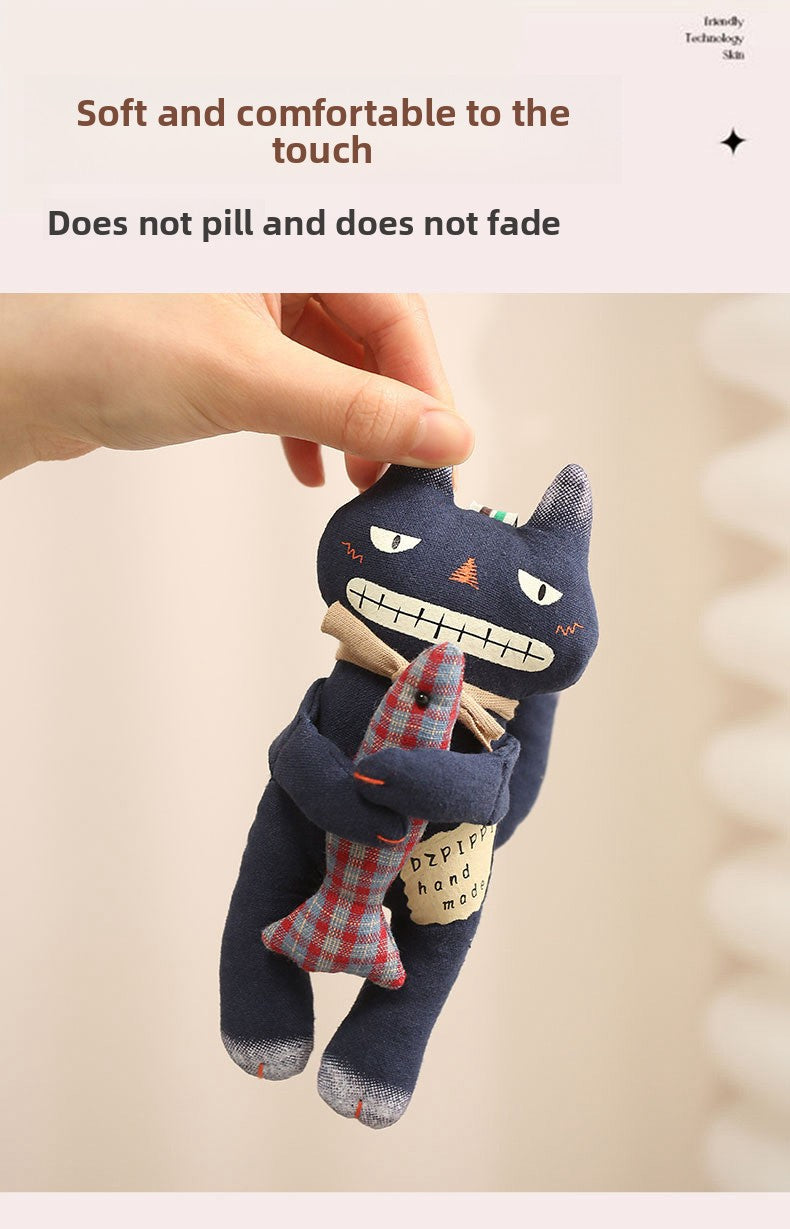 Soft and comfortable fabric display of a black cat bag charm held by hand
