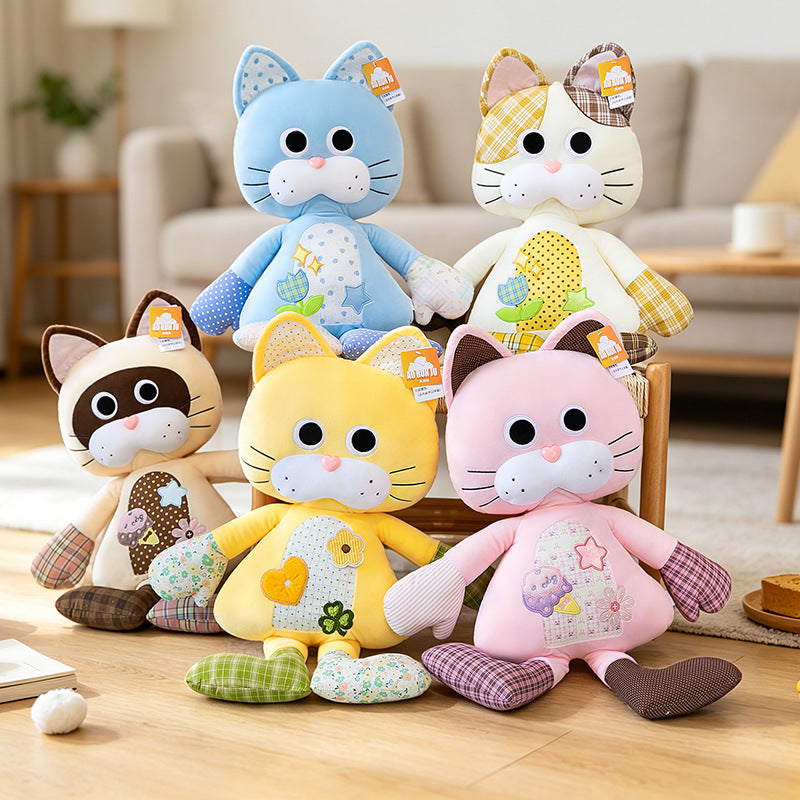 A collection of colorful patchwork cat stuffed animals in blue, pink, yellow, and brown on a chair