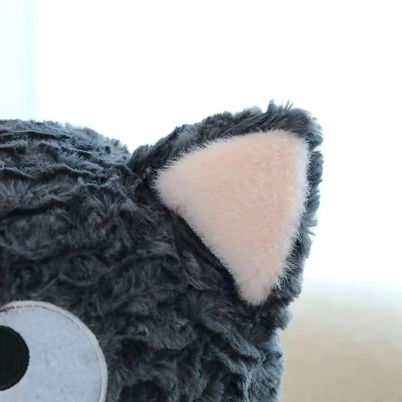 Close up view of the curly sherpa plush fabric on the black cat stuffed animal ear