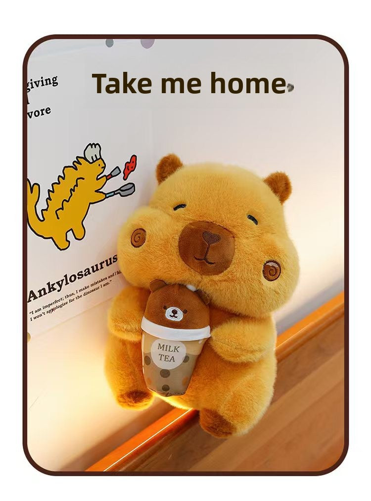 Cute orange boba capybara plushie leaning against a wall next to funny dinosaur drawings