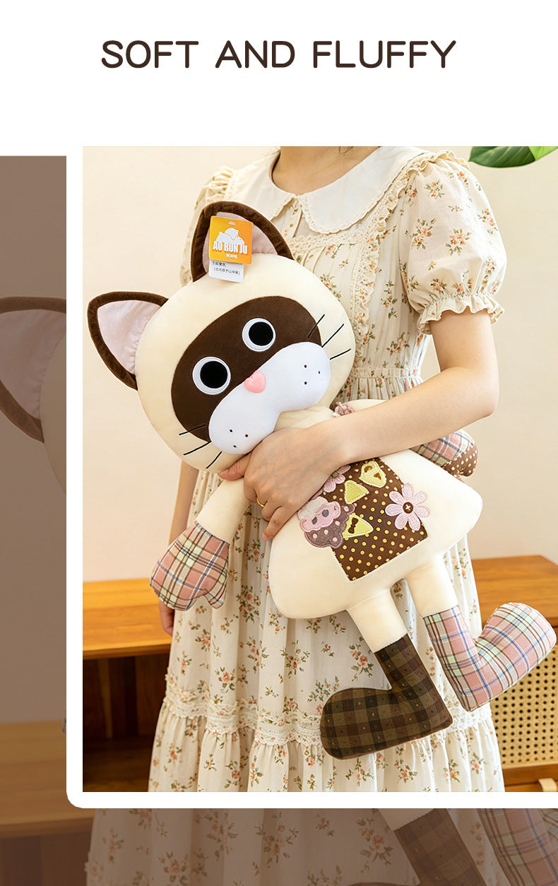 Soft floral patchwork brown cat plushie being held by a person showing its huggable plush body