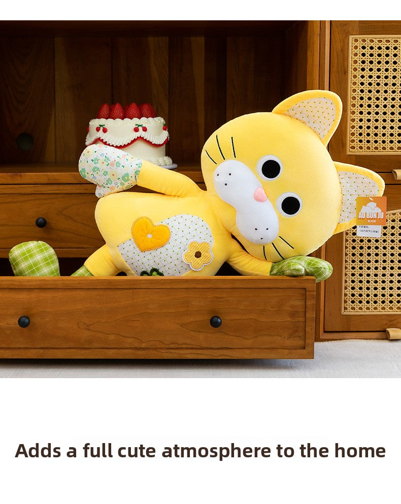 Funny orange cat stuffed animal with long limbs relaxing inside a wooden drawer for room decor
