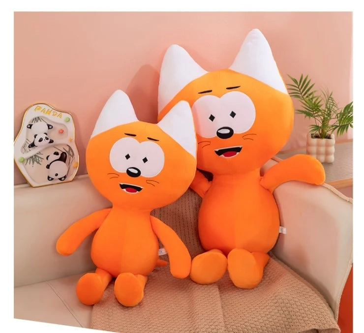  Funny quirky orange cat plush toys sitting nicely on a living room sofa