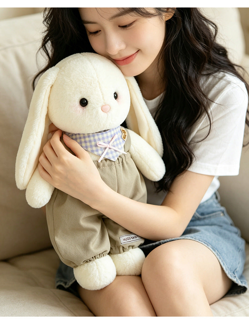 Young girl hugging soft khaki-outfit bunny plushie on cozy sofa, lifestyle cuddle scene