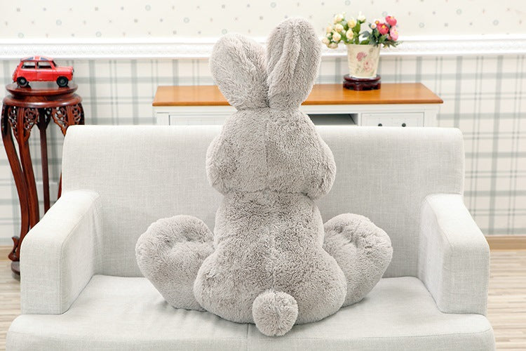 Back view of fluffy gray stuffed bunny | long ear bunny plushie | soft rabbit plush toy sitting on sofa