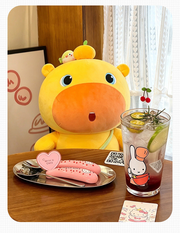 Cute orange capybara plush toy placed on wooden table in cafe, cozy lifestyle shot