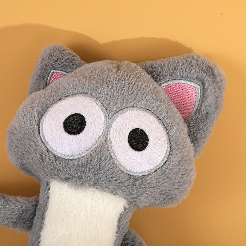 Close-up of funny quirky grey cat plush toy head with humorous expression and embroidered eyes