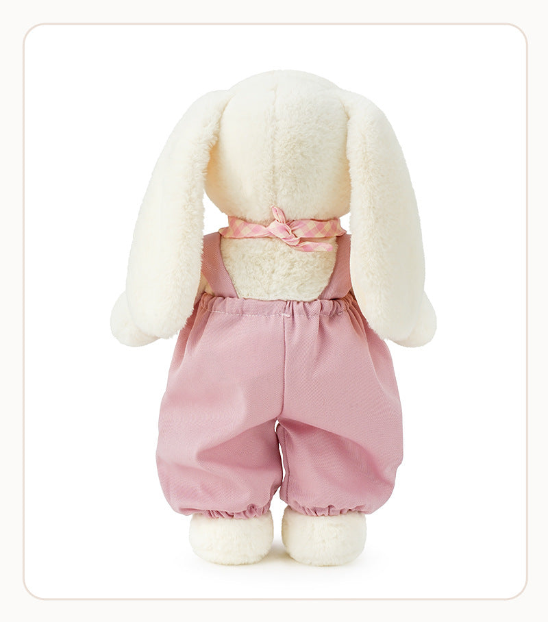 Back view of dressed lop-eared stuffed bunny showing checkered scarf bow and pink overalls