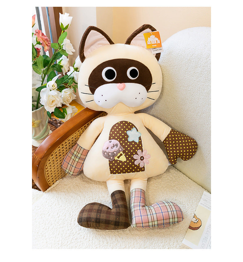 Vintage patchwork siamese cat plush pillow decorated on a cozy sofa next to flowers
